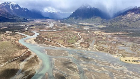 Landscape of mountains and braided river channels.