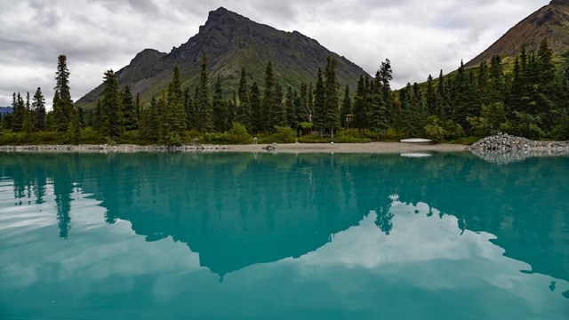mountains and autumnal trees reflect in Twin Lakes
