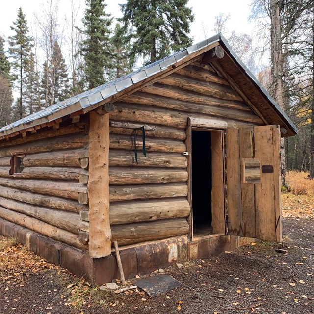 a wooden cabin with the door open