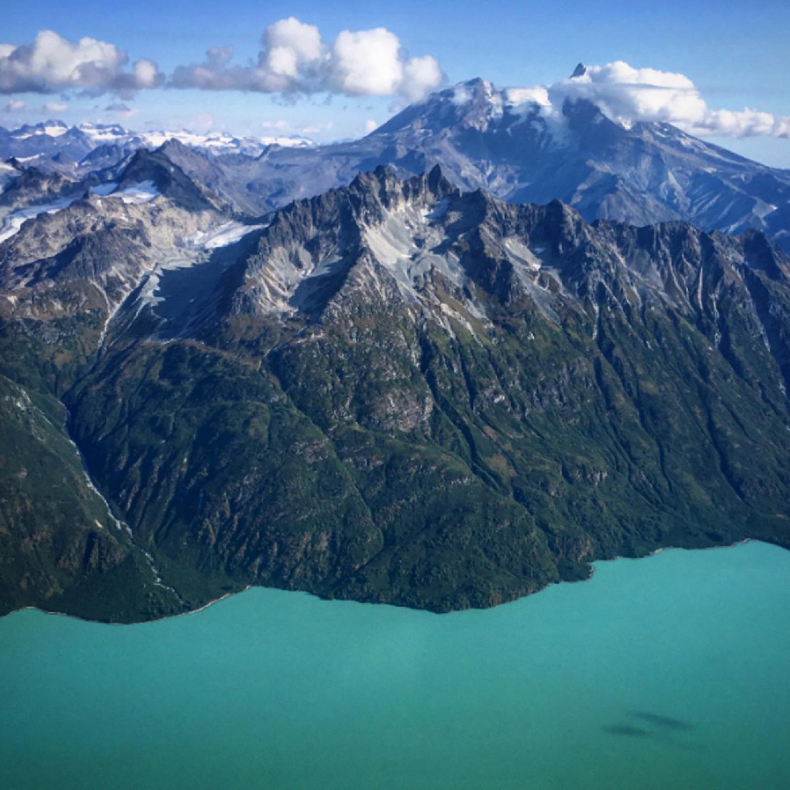 Staring down at a bright blue lake circled by steep mountains