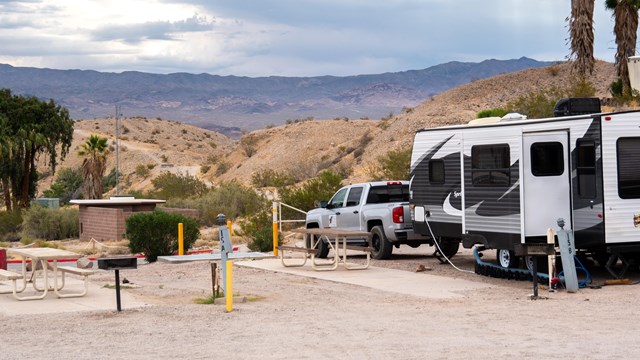 A RV with a desert landscape.