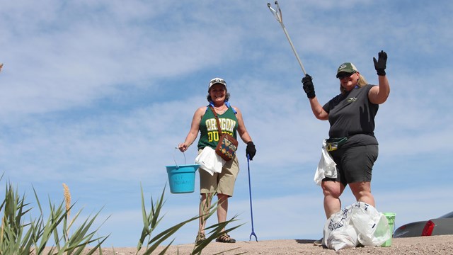 Two volunteers picking up trash.