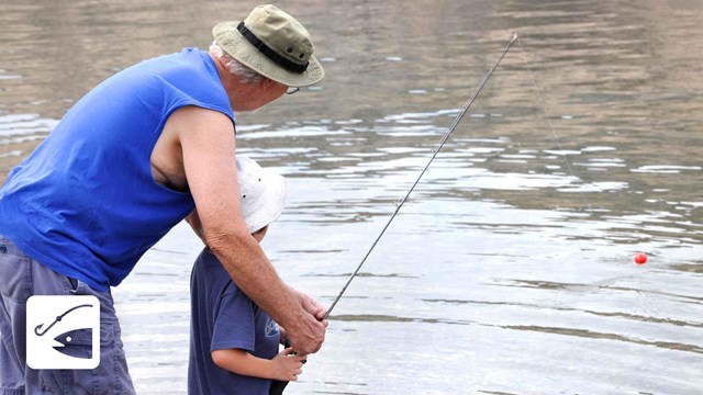 Man helping a child with a fishing pole
