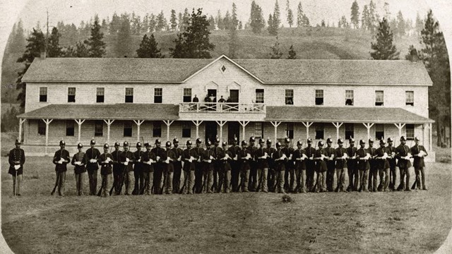 historic photos of soldiers standing in front of Fort Spokane guardhouse