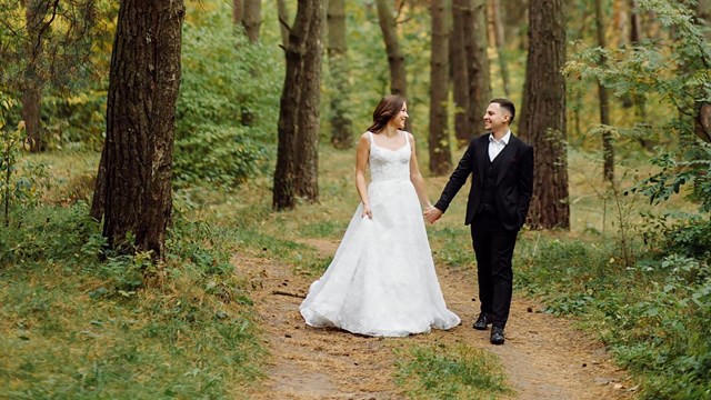 A bride and groom in the woods.