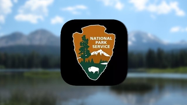 NPS app icon over a blurred image of a mountain and lake