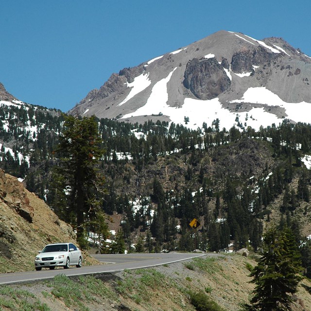 Vehicle on park highway with Lassen Peak in background