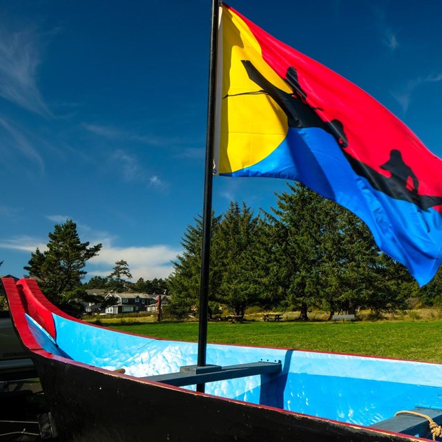 canoe with Clatsop Nation flag