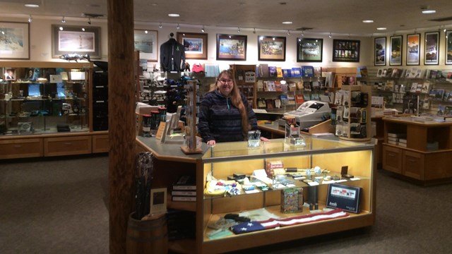 Partner cashier standing in the Lewis and Clark National park Association Bookstore