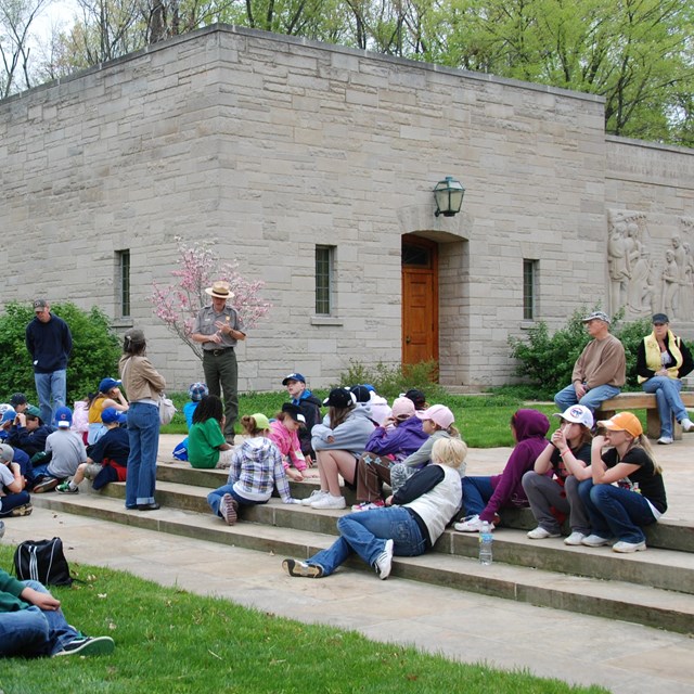 Park Ranger talking with students during visit to the Memorial Visitor Center.