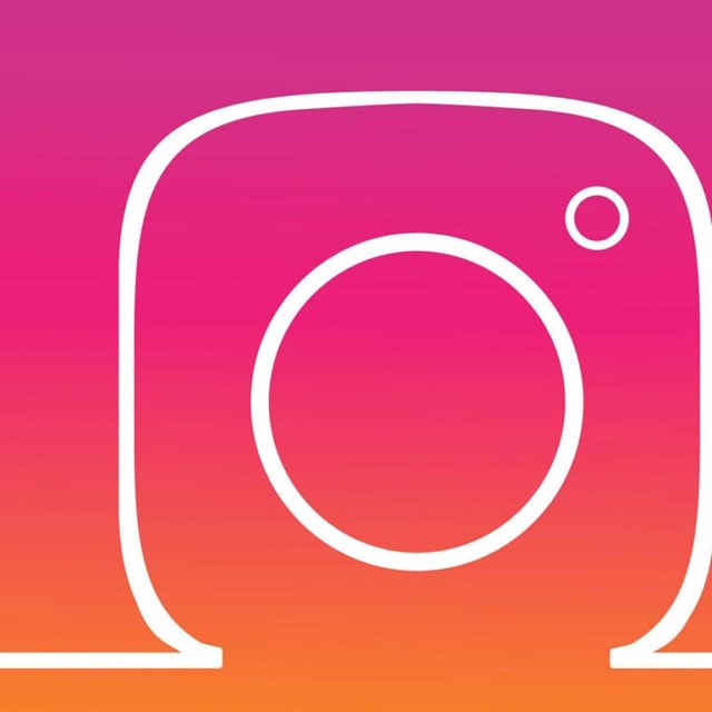 A white line forms the outline of the Instagram camera logo against a pink and orange background