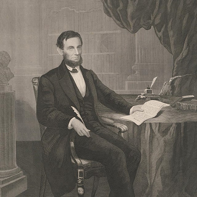 Bearded Lincoln sitting at Desk with Emancipation Proclamation