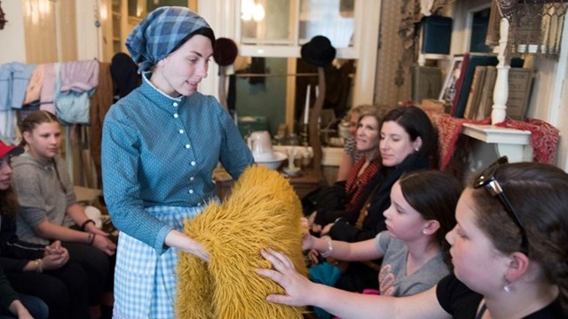 School children touch fuzzy yellow fabric