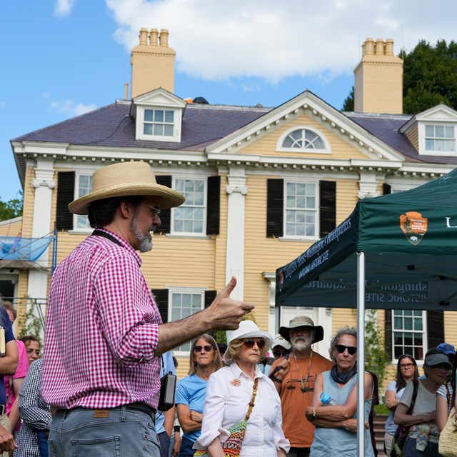 Tour guide speaking with visitors outdoors