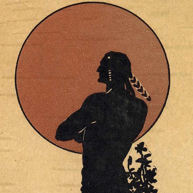 Silhouette of Native American in front of red sun