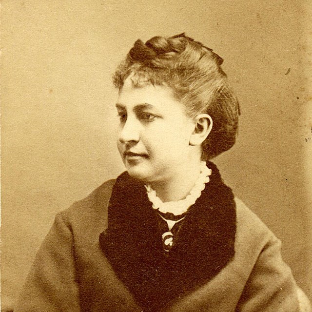 Portrait of young woman in coat with dark collar