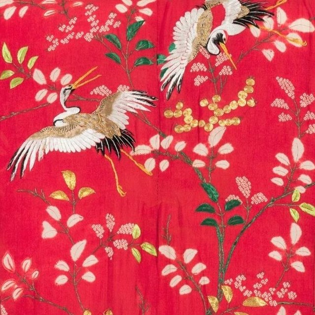 Back shoulders of red silk kimono with crane and leaf embroidery