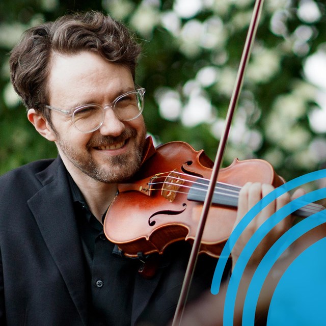 Man playing a violin outdoors