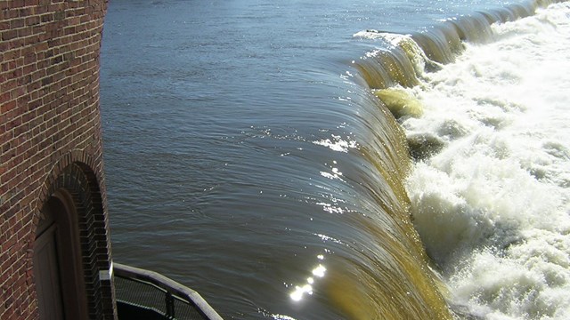 Water flows over the Pawtucket Dam in Lowell