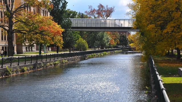 A canal cuts through a downtown park