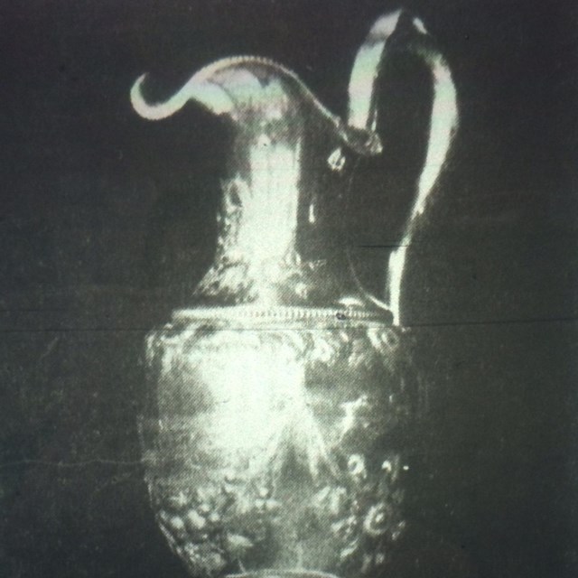 An ornate silver pitcher