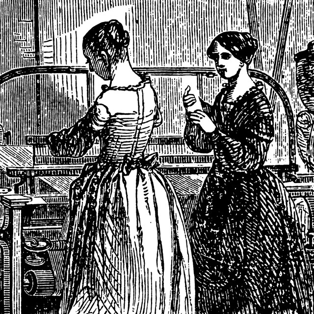 Two women work at a power loom