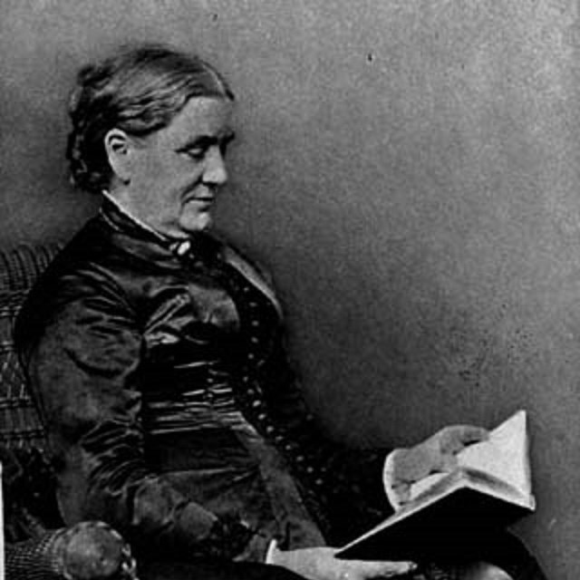 a woman sitting in a chair with a book in her lap
