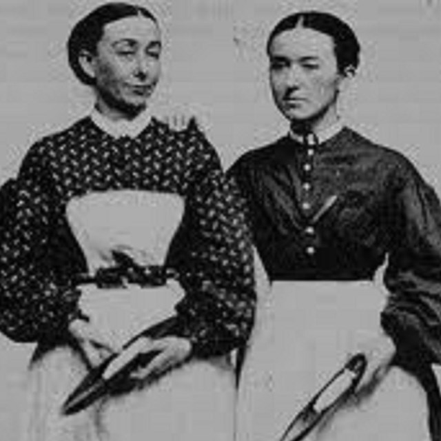 Two women standing side by side