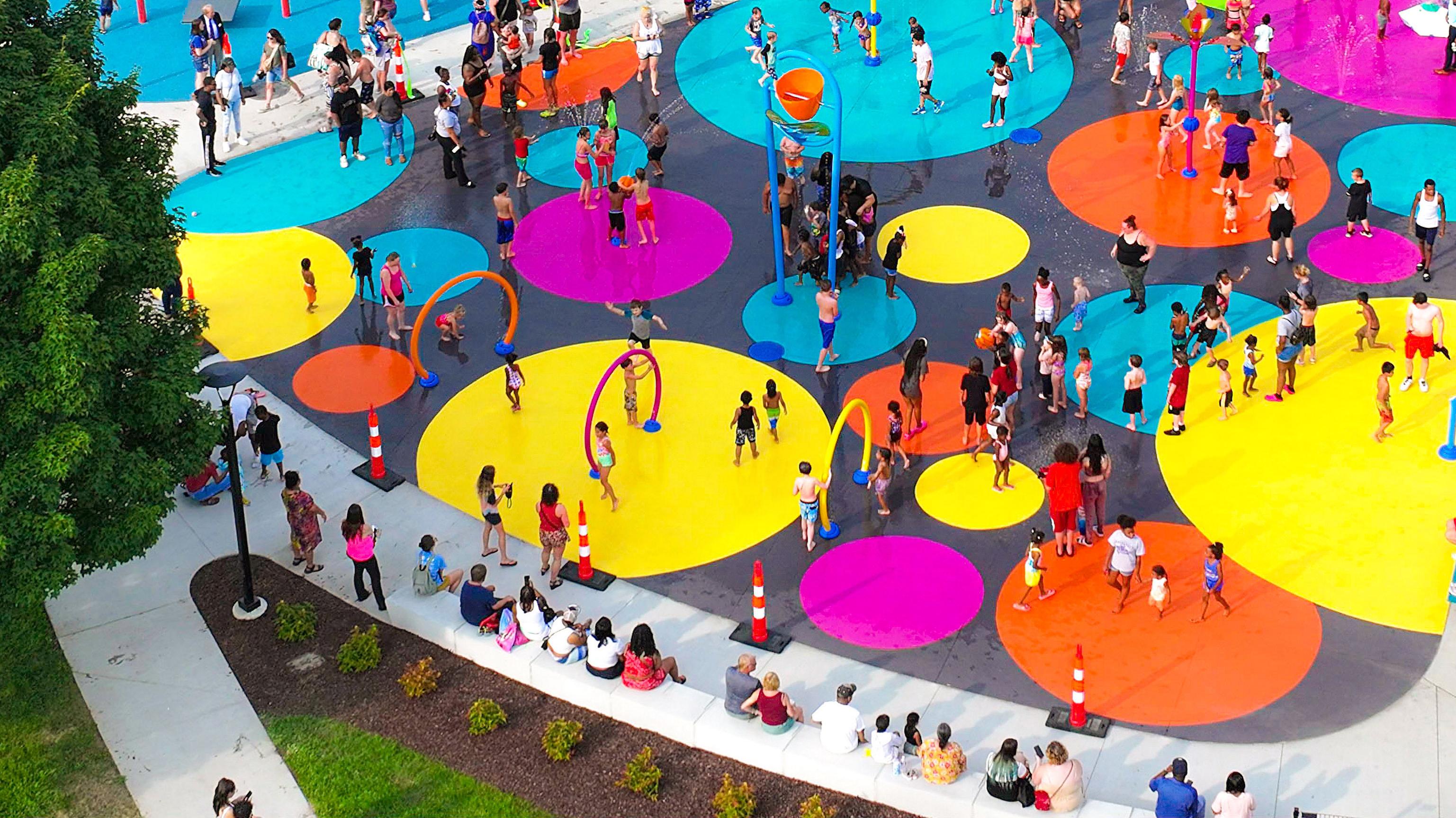 a park with large colorful discs and many children