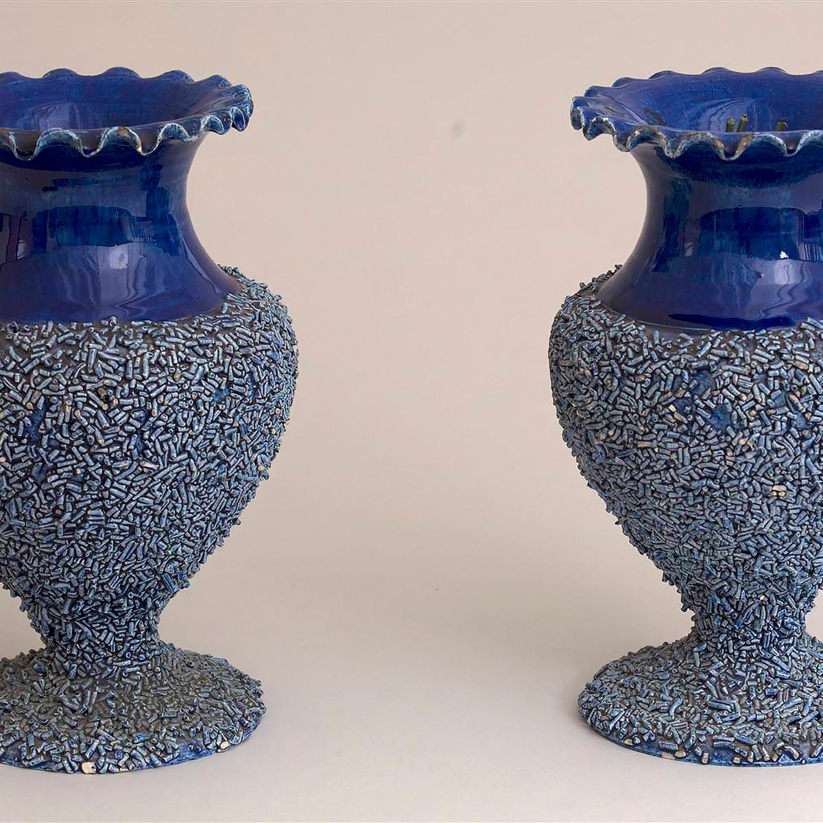 Two matching beaded blue vases side by side
