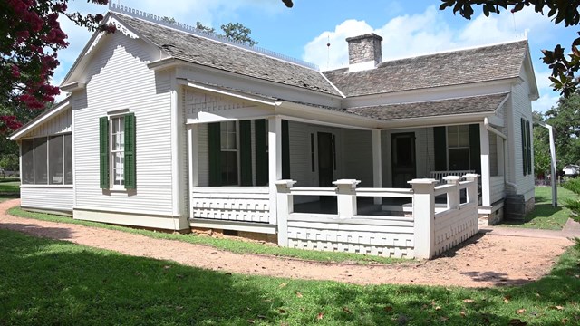 White house with a porch on every corner