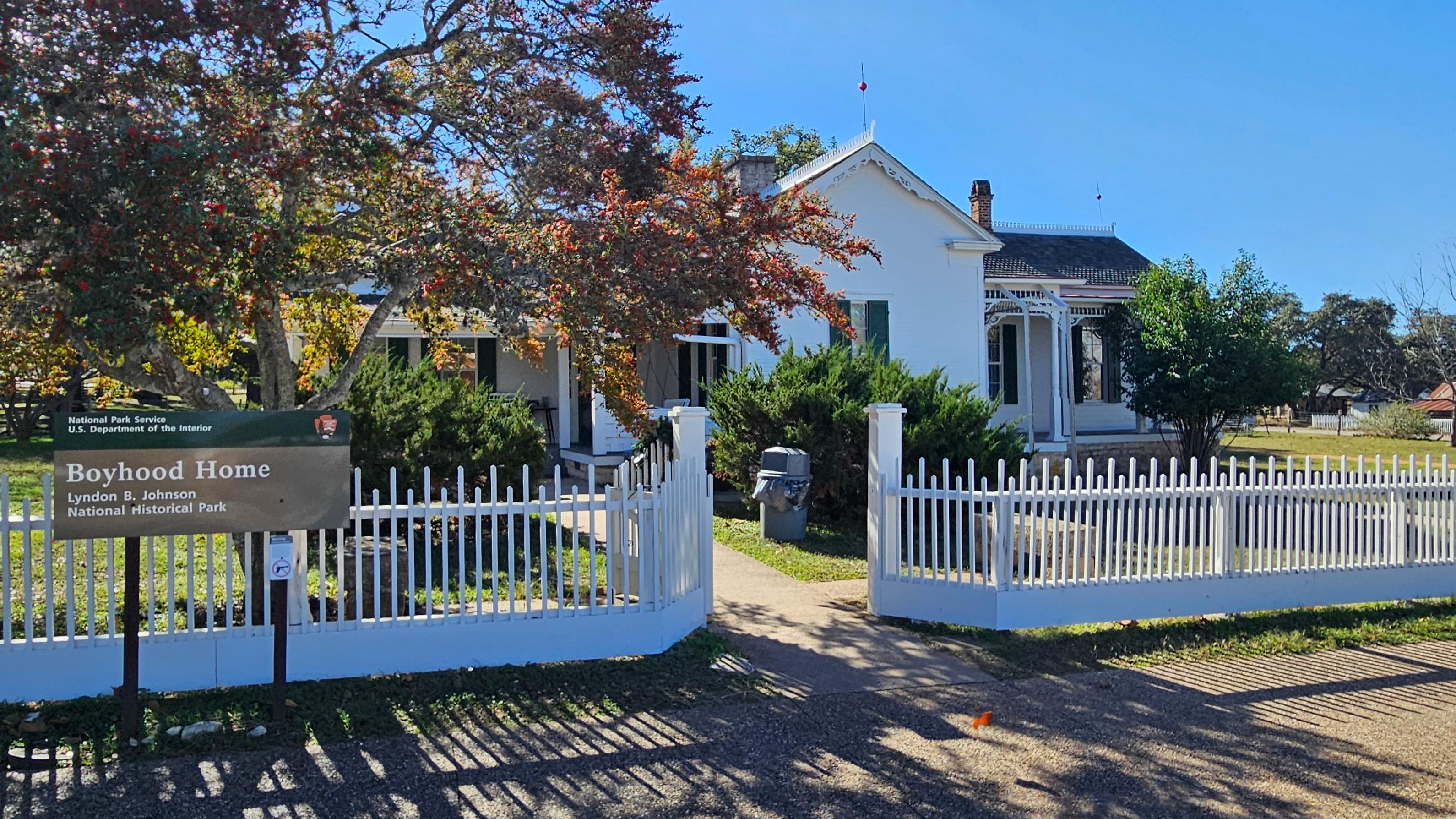 Small, white house with white picket fence
