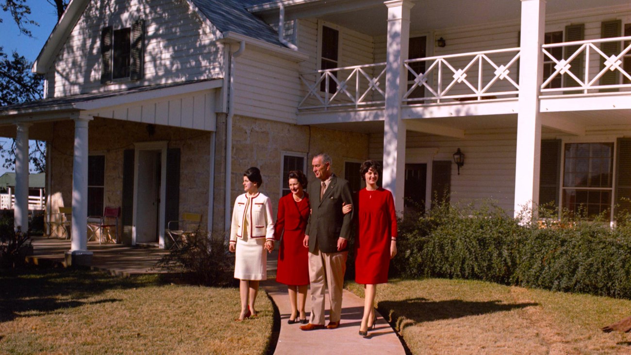 The Johnson family of Lyndon, Lady Bird, Lynda and Luci walk in front of the Texas White House.