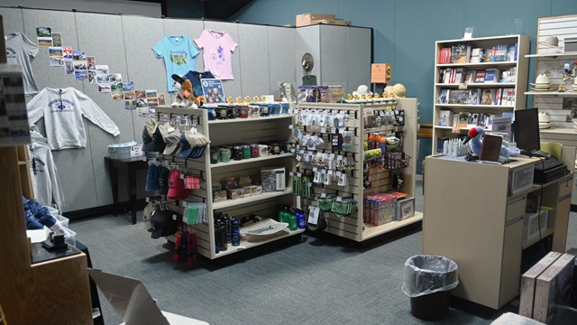 Store selling t shirts, hats, books, and other souvenirs.