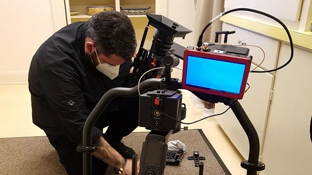 A photographer adjusts his equipment before filming.