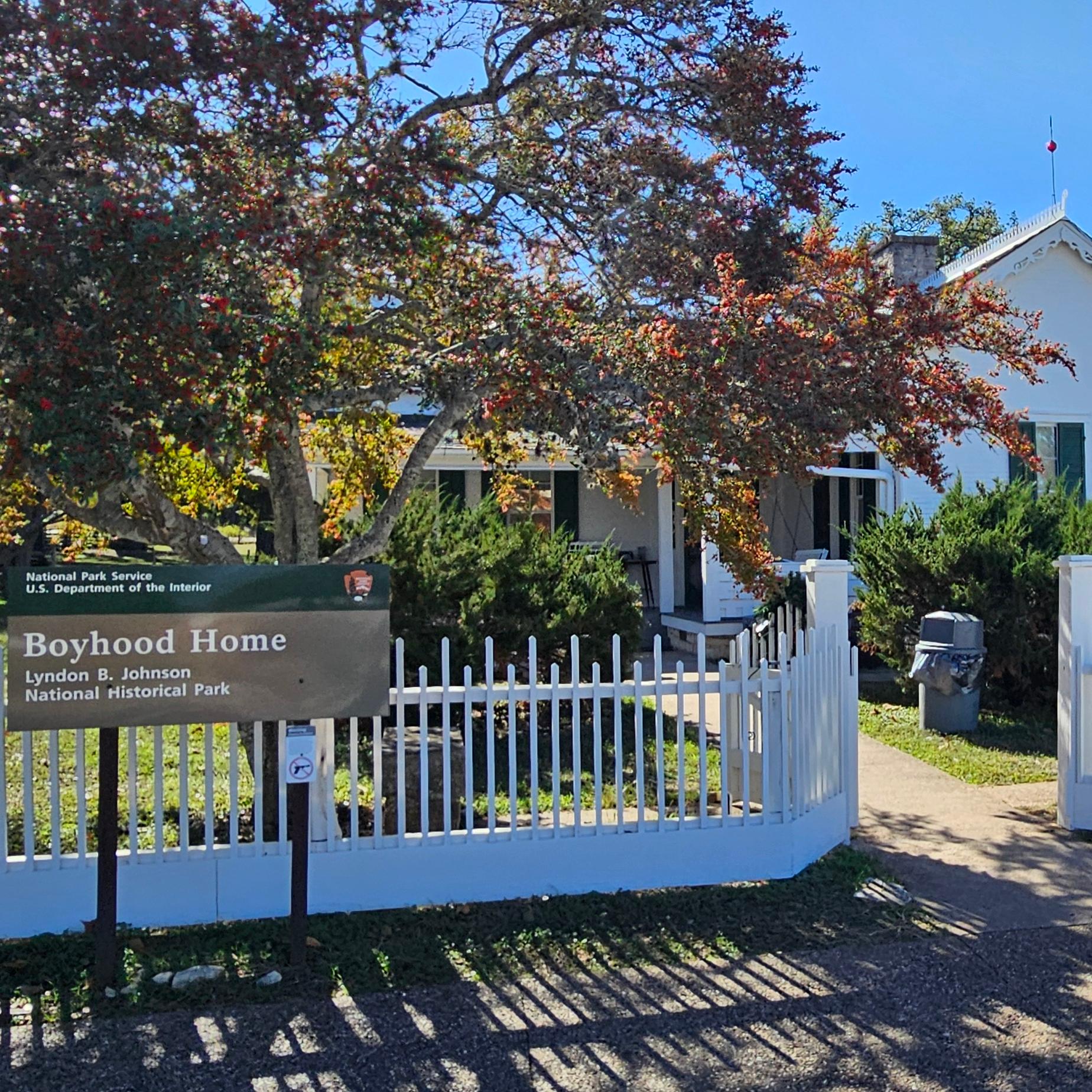 Small, white house with white picket fence