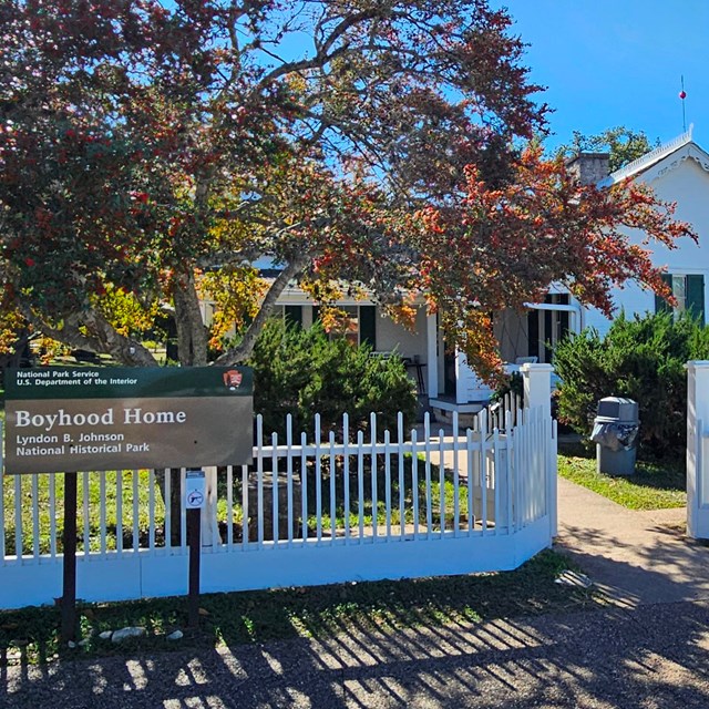 Small, white house with white picket fence