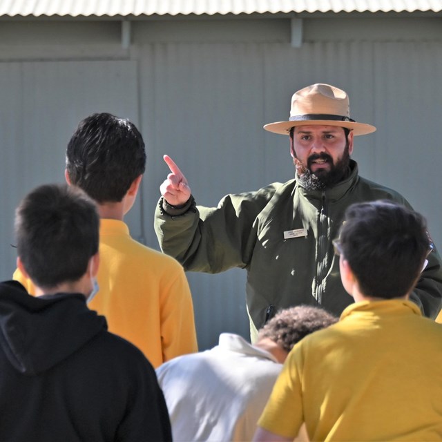 A ranger gives an education program to students. 