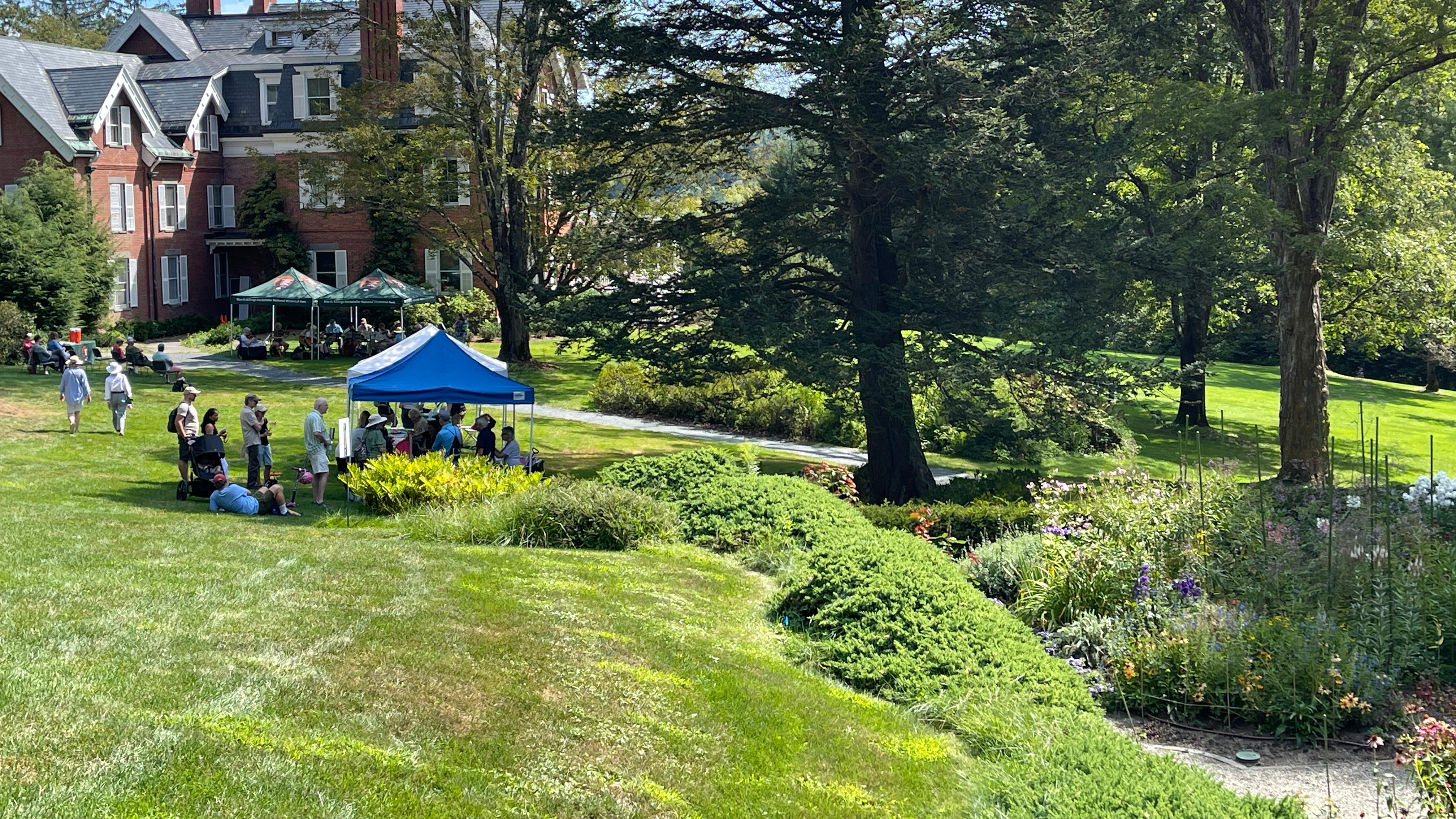 long lawn on hill with formal garden on right