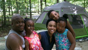 A family enjoys the day in the campground.