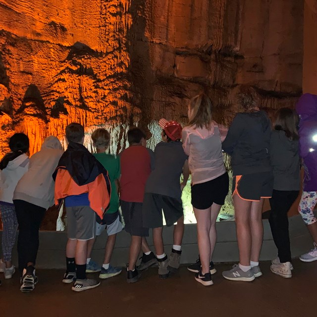 A group of students looking at cave formations.