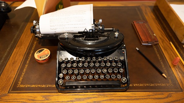 A typewriter on a desk.