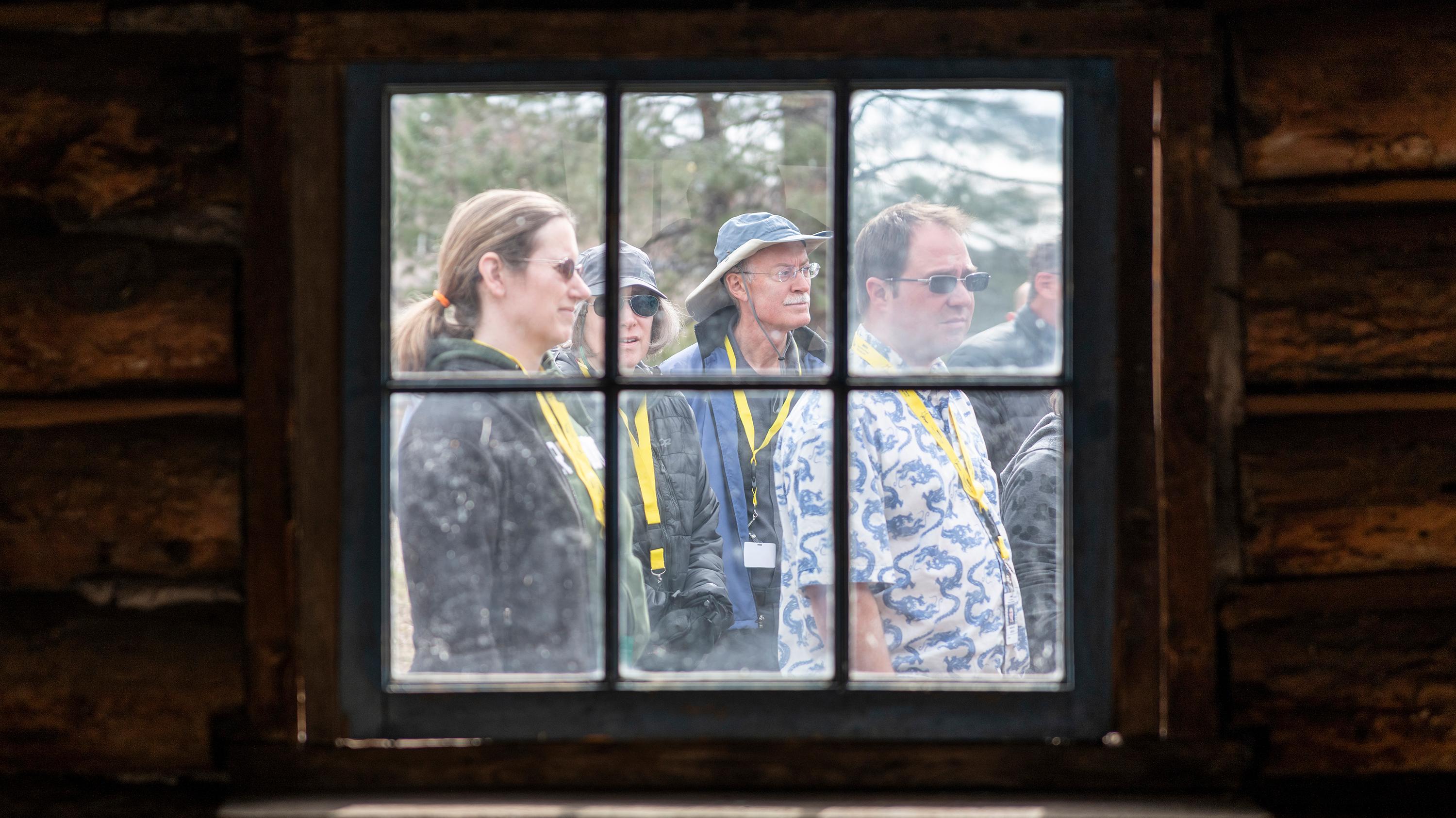 People gather outside a window.