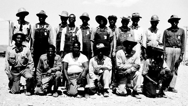A black and white photo of a group of African American men in uniform.