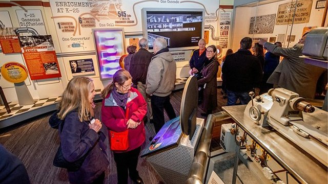 Several people viewing exhibits inside a museum.