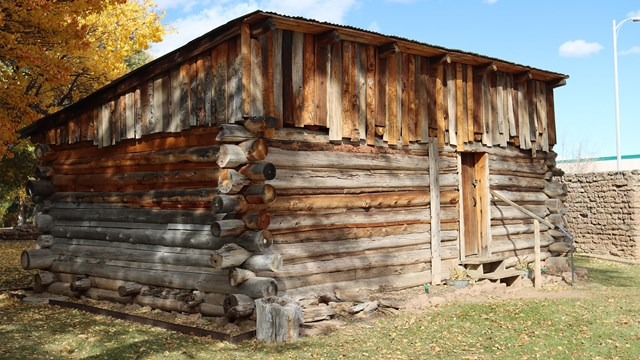 A historic, rustic wooden cabin.