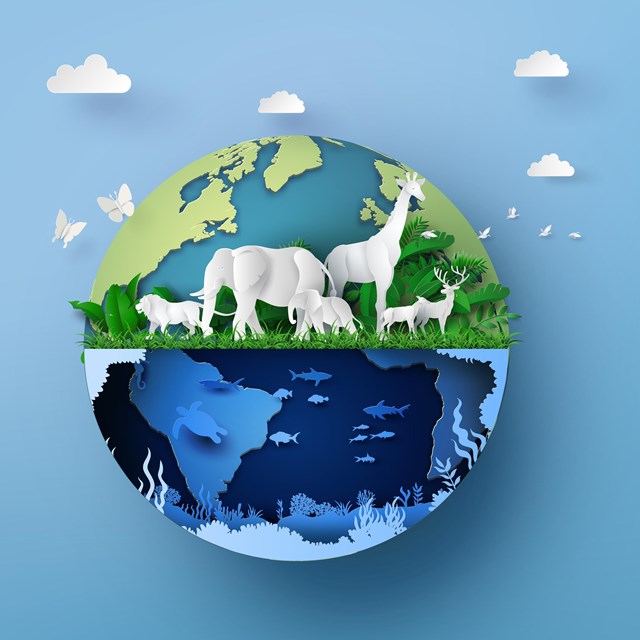 Paper-style Earth with land animals, ocean life, and plants, symbolizing biodiversity.
