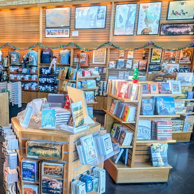 Books, gifts, souvenirs, are set on wood four-sided displays and on wall shelves