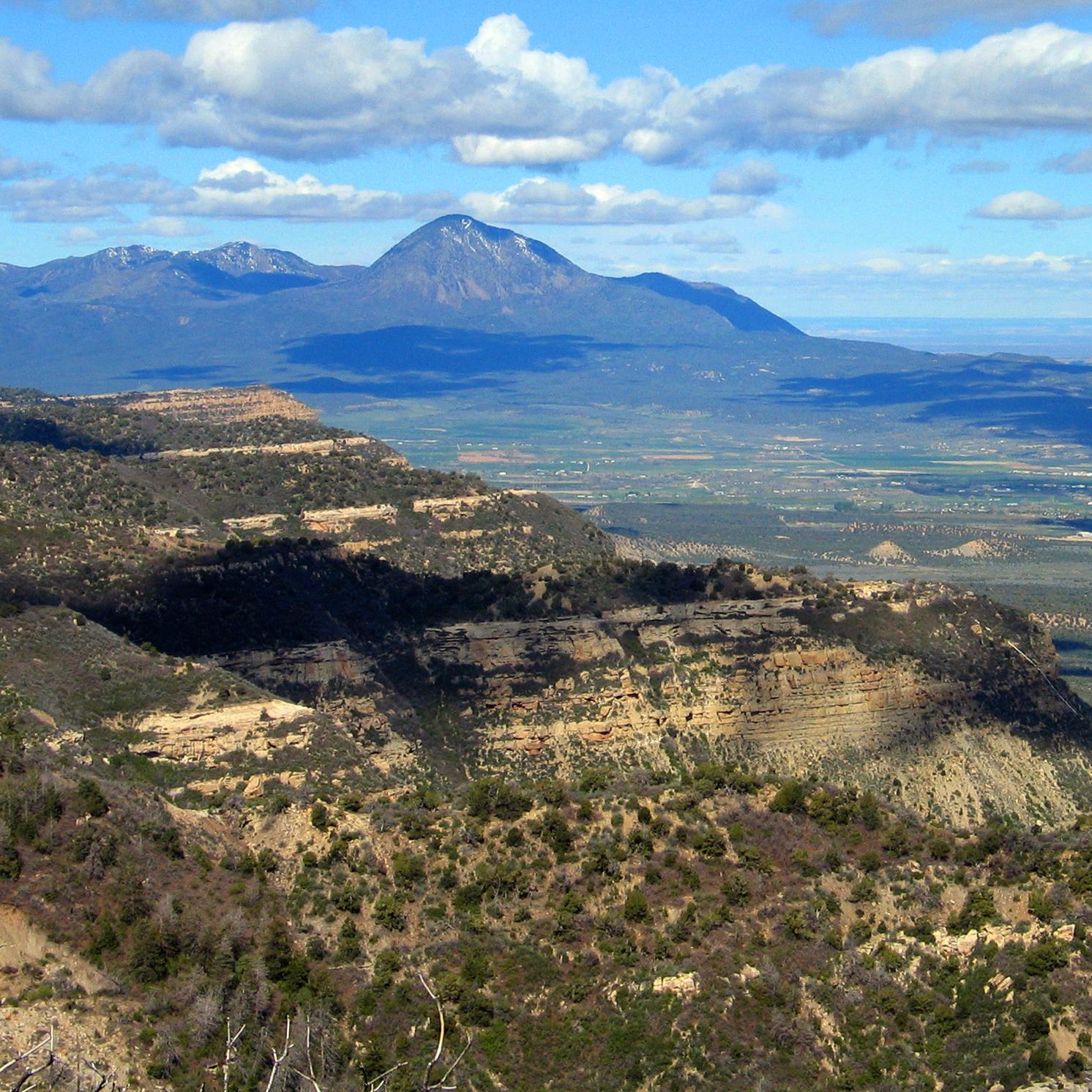 a landscape view looking west across towards a high peak 