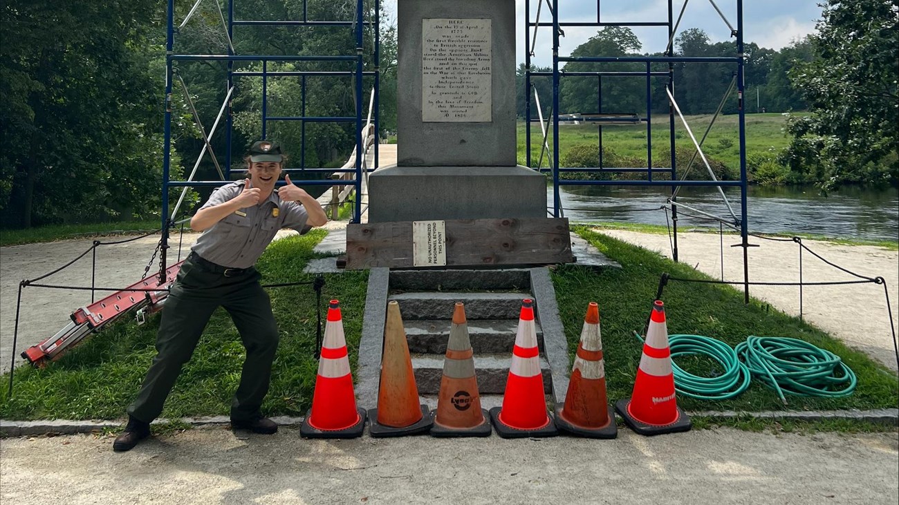 A stone obelisk monument surrounded by scaffolds and construction cones.